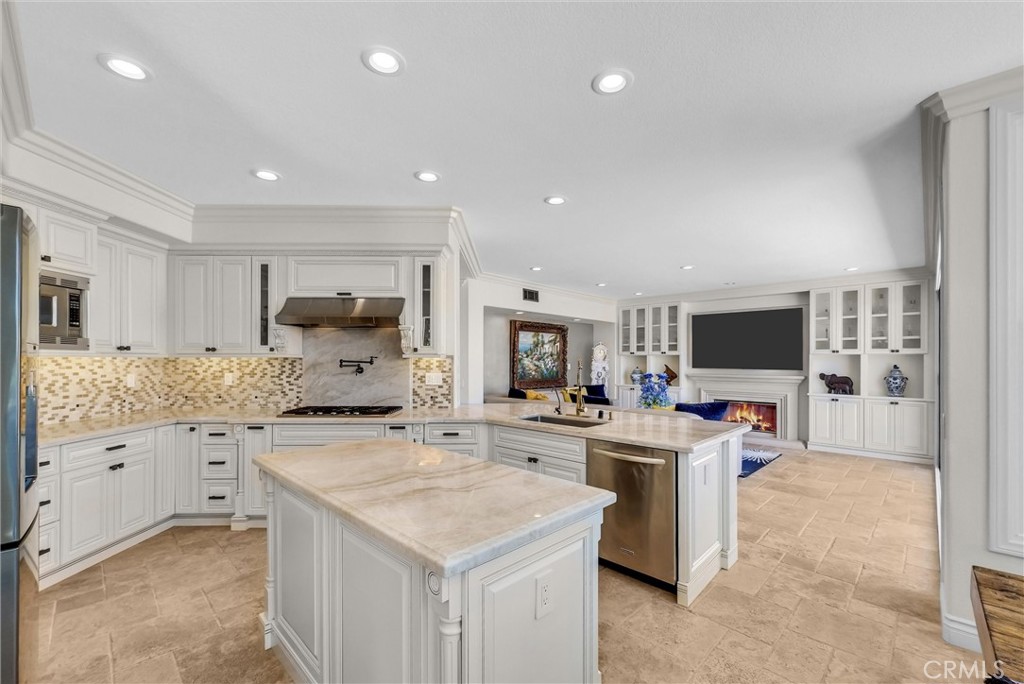 25672 Raintree Road Laguna Hills, CA 92653 - Photo 17 of 50 a kitchen with counter top space sink and center island