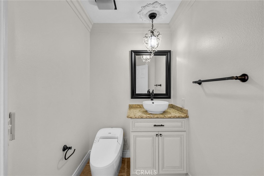 25672 Raintree Road Laguna Hills, CA 92653 - Photo 21 of 50 a bathroom with a granite countertop sink and a mirror
