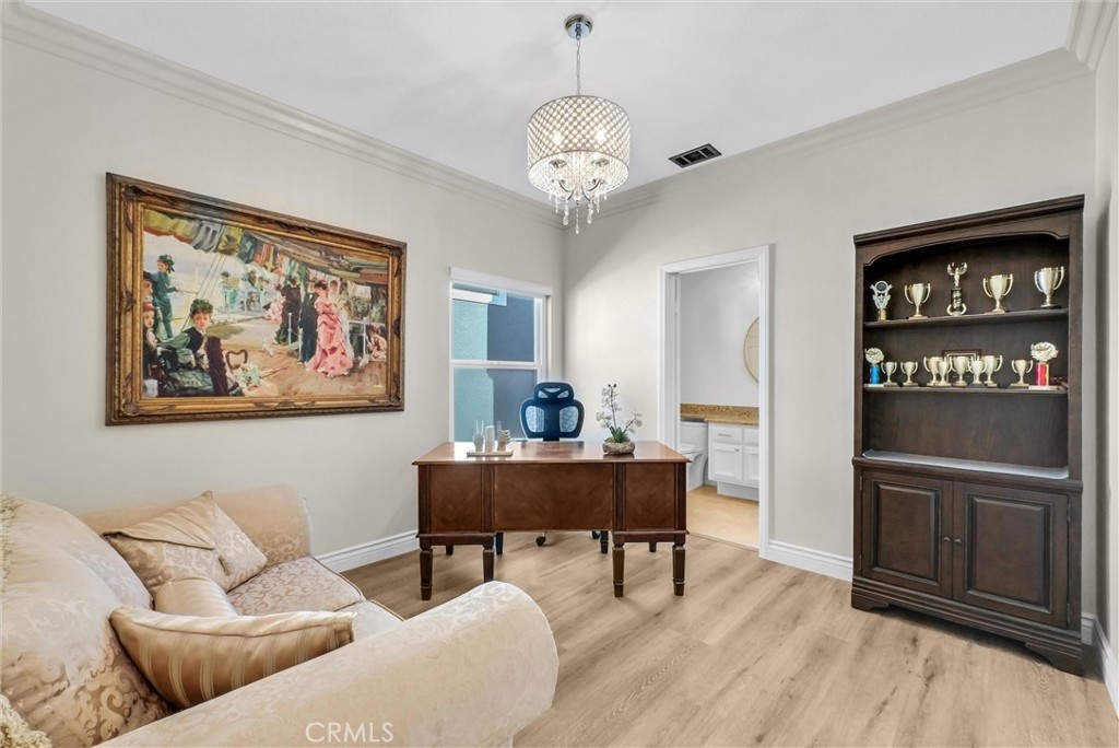 25672 Raintree Road Laguna Hills, CA 92653 - Photo 35 of 50 a living room with furniture a chandelier and a dining table