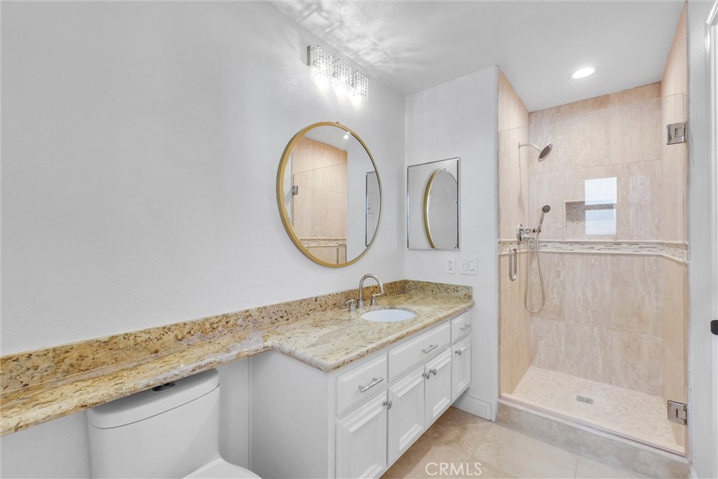 25672 Raintree Road Laguna Hills, CA 92653 - Photo 37 of 50 a bathroom with a granite countertop double vanity sink and a mirror