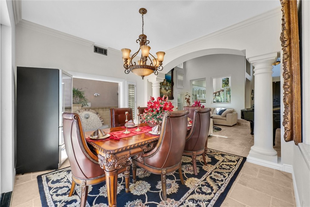 25672 Raintree Road Laguna Hills, CA 92653 - Photo 9 of 50 a view of a dining room with furniture and a chandelier