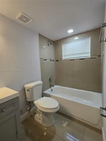 a bathroom with a toilet and a bath tub