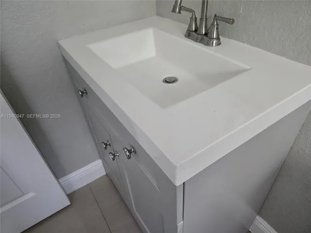 a bathroom with a sink and shower