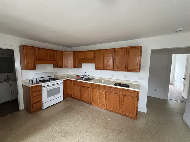 a kitchen with stainless steel appliances granite countertop a stove sink and cabinets