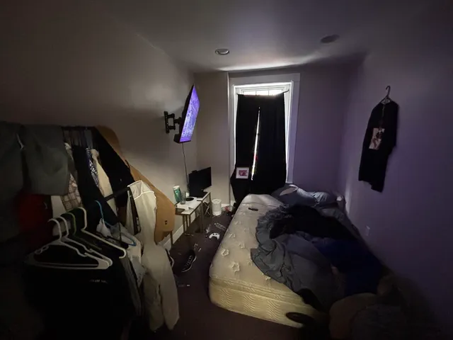 a bed room with a bed and a mirror