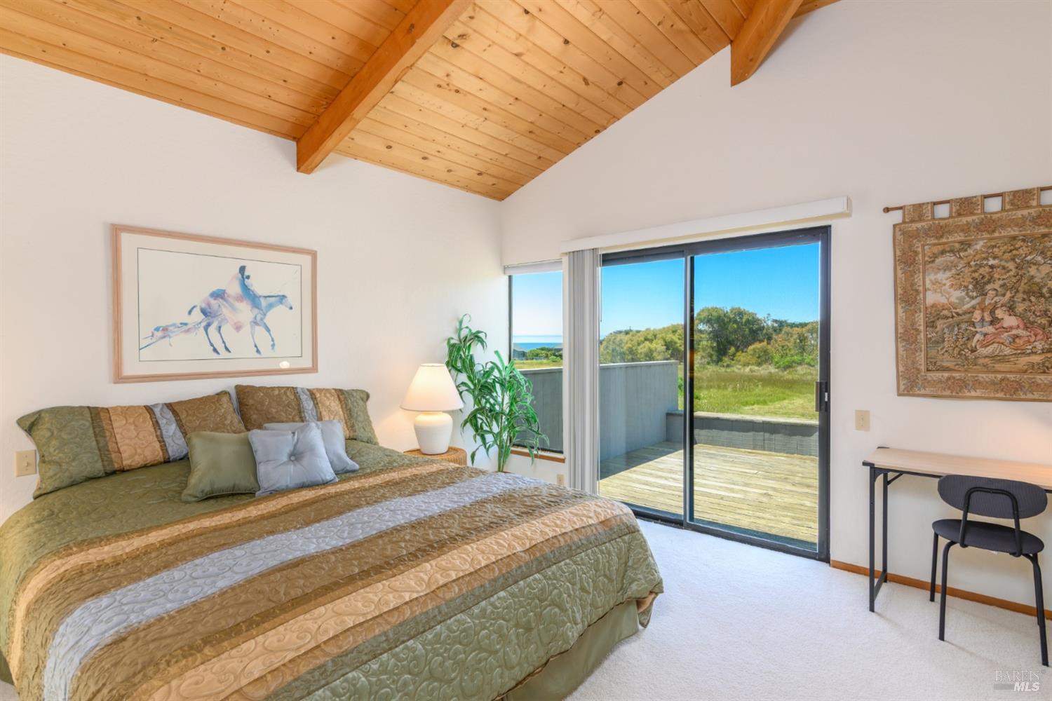 267 Sea Stack The Sea Ranch, CA 95497 - Photo 25 of 35 a bedroom with a large bed and a large window