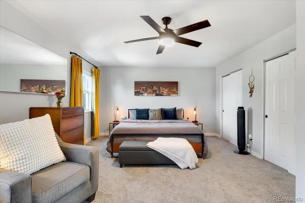 a bedroom with a bed couch and window