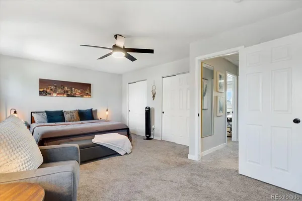 a bedroom with a bed and a ceiling fan
