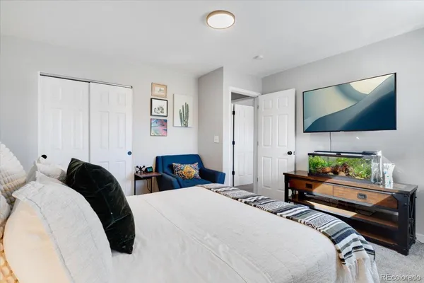 a bedroom with a bed and a flat screen tv