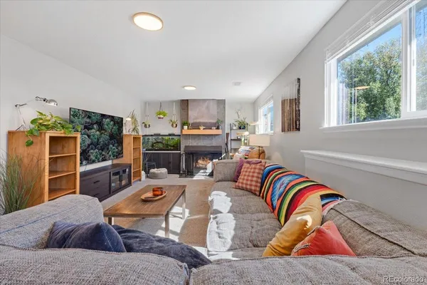 a living room with furniture fireplace and flat screen tv