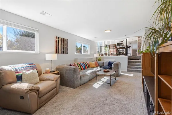 a living room with furniture a flat screen tv and a window
