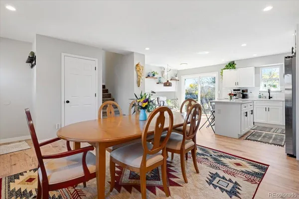 a dining room with furniture and wooden floor
