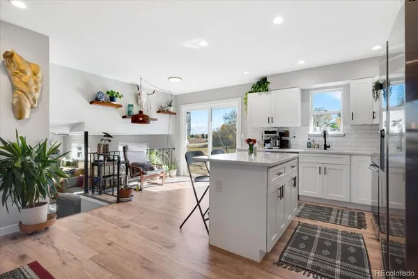 a kitchen with cabinets and wooden floor