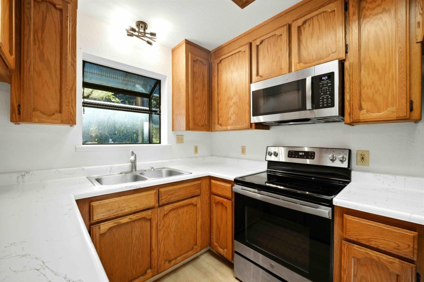 178 Madrona Road Boulder Creek, CA 95006 - Photo 12 of 22 a kitchen with stainless steel appliances a stove microwave and sink