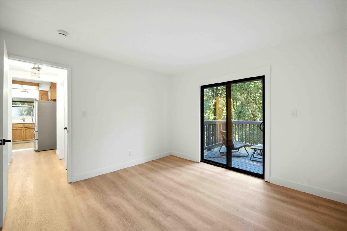 178 Madrona Road Boulder Creek, CA 95006 - Photo 16 of 22 an empty room with sliding door and wooden floor