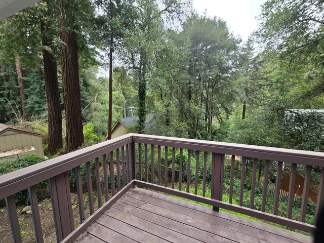 a view of balcony with deck and trees