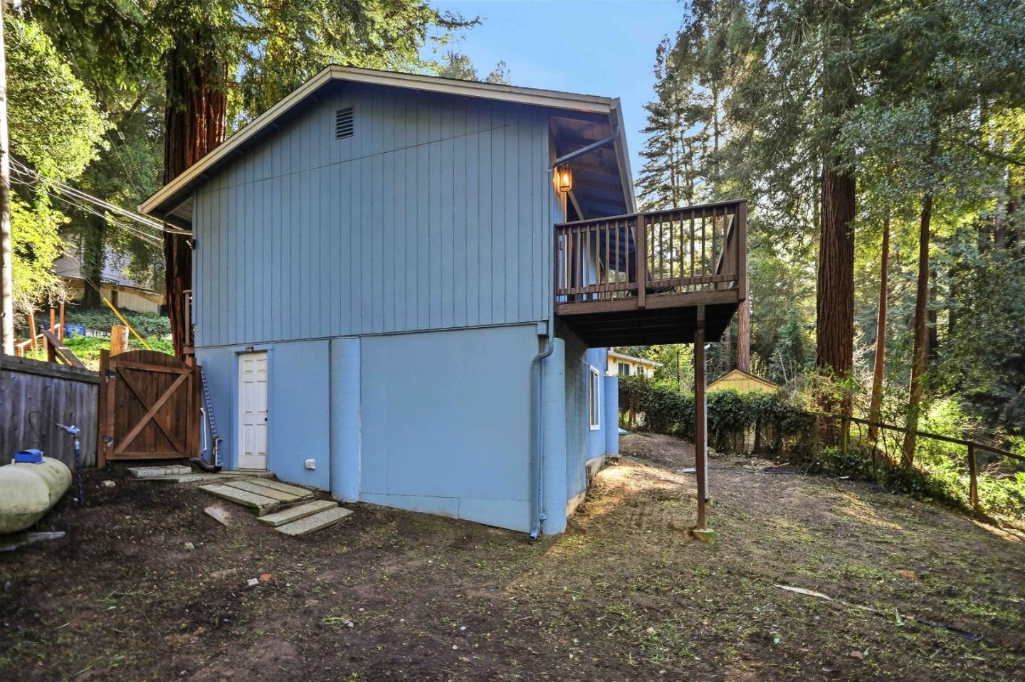 178 Madrona Road Boulder Creek, CA 95006 - Photo 8 of 22 a backyard of a house with barbeque oven table and chairs