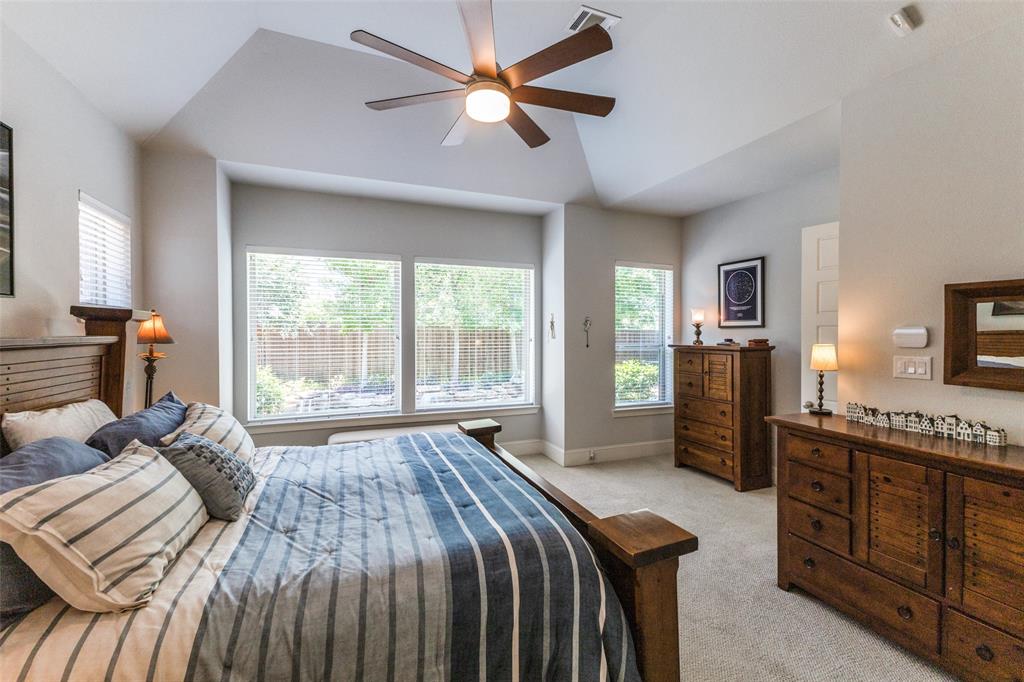 4008 North Cresthaven Road Dallas, TX 75209 - Photo 14 of 37 a spacious bedroom with a bed a dresser and a chandelier