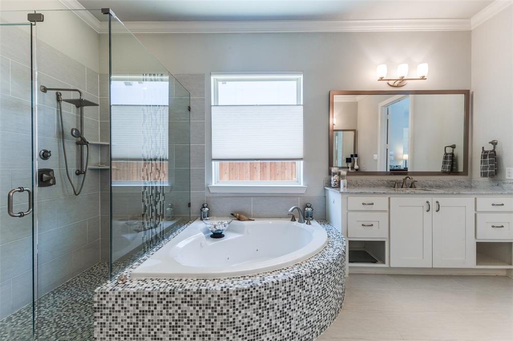 4008 North Cresthaven Road Dallas, TX 75209 - Photo 15 of 37 a bathroom with a double vanity sink a mirror and a shower