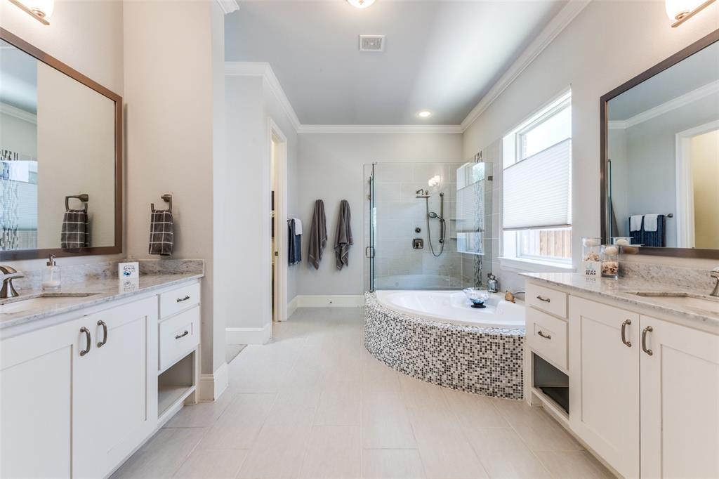4008 North Cresthaven Road Dallas, TX 75209 - Photo 16 of 37 a spacious bathroom with a double vanity sink a mirror a bathtub and shower