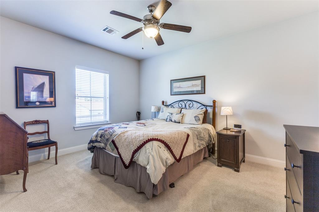 4008 North Cresthaven Road Dallas, TX 75209 - Photo 27 of 37 a bedroom with a bed and a chandelier