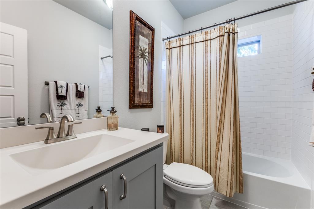 4008 North Cresthaven Road Dallas, TX 75209 - Photo 28 of 37 a bathroom with a sink a toilet and shower
