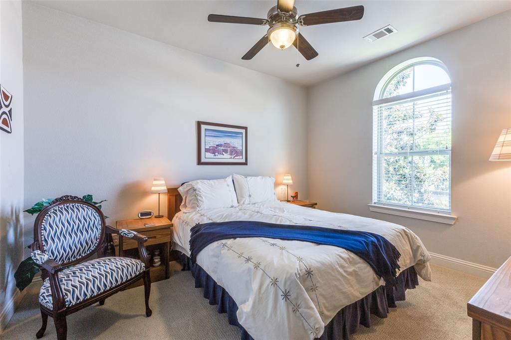 4008 North Cresthaven Road Dallas, TX 75209 - Photo 29 of 37 a bedroom with a bed couch and a window