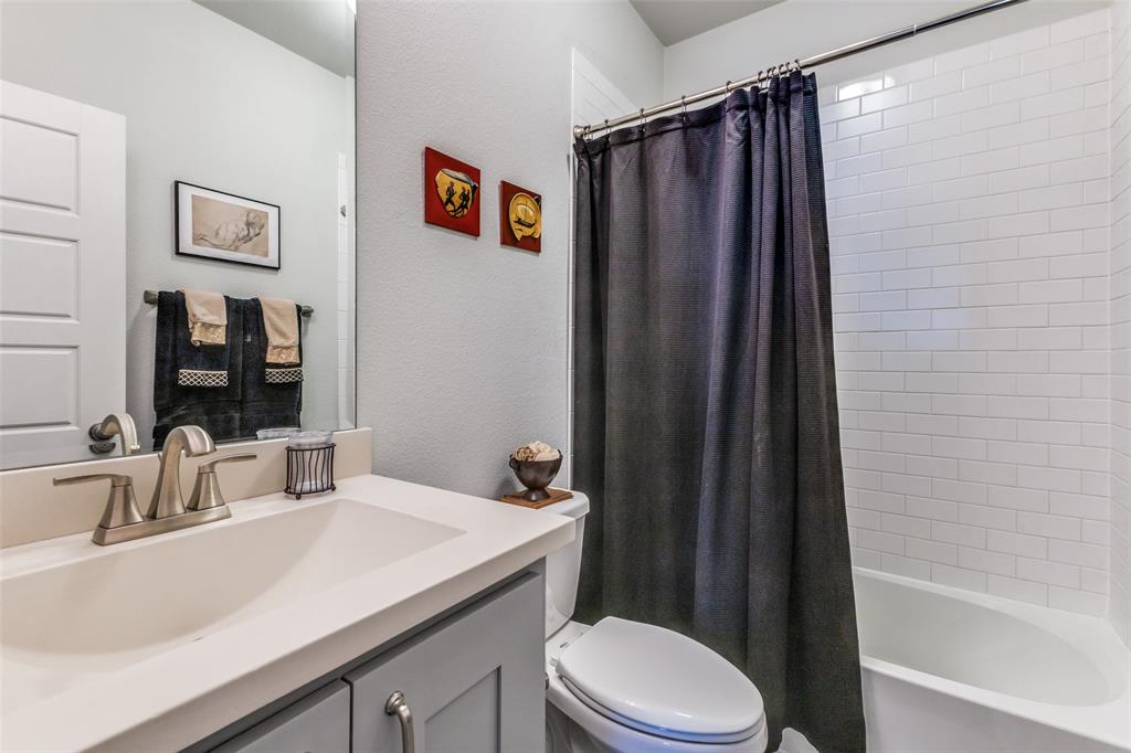 4008 North Cresthaven Road Dallas, TX 75209 - Photo 30 of 37 a bathroom with a sink a toilet a shower curtain and a bath tub