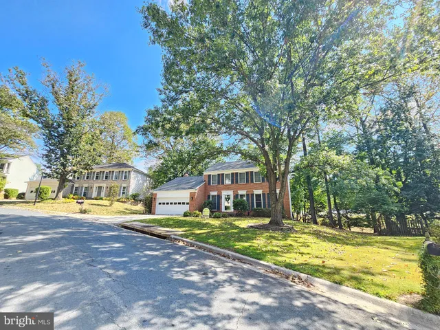a view of a swimming pool with a house in the background