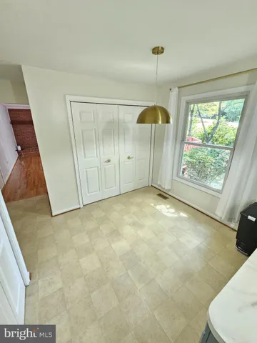 a kitchen with stainless steel appliances a sink a stove a refrigerator cabinets and living room view