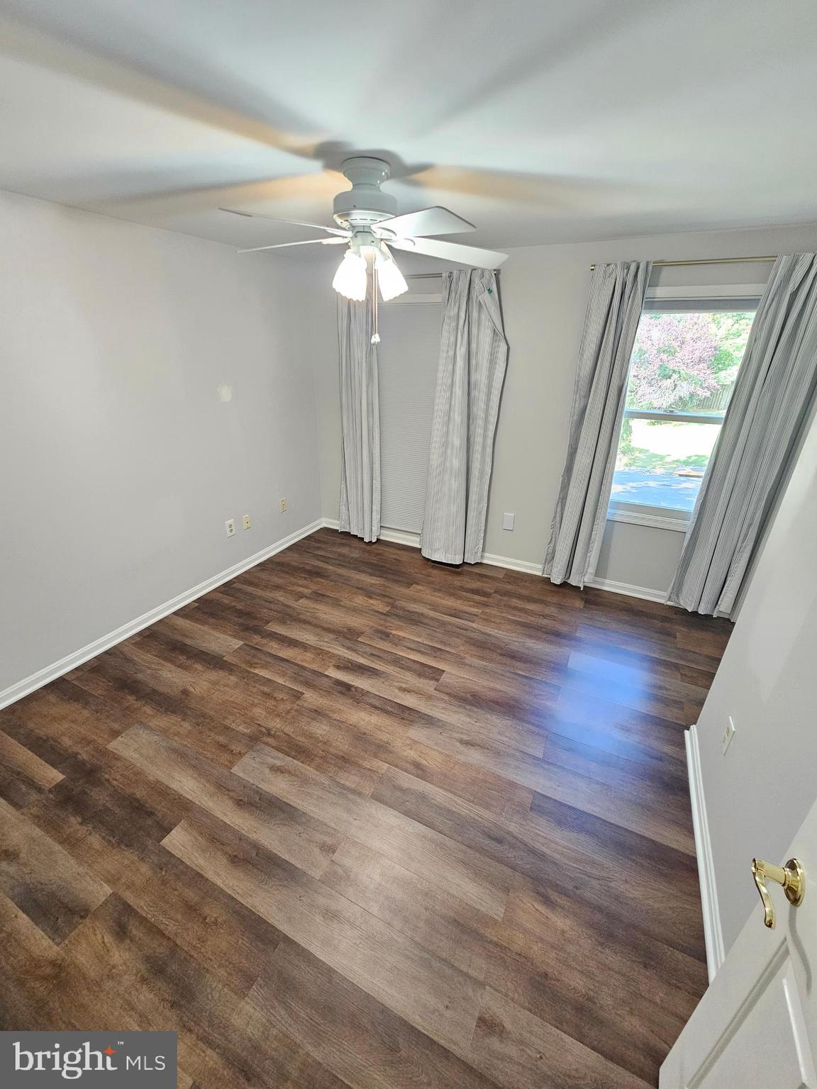 11321 Classical Lane Silver Spring, MD 20901 - Photo 27 of 66 wooden floor in an empty room with a window