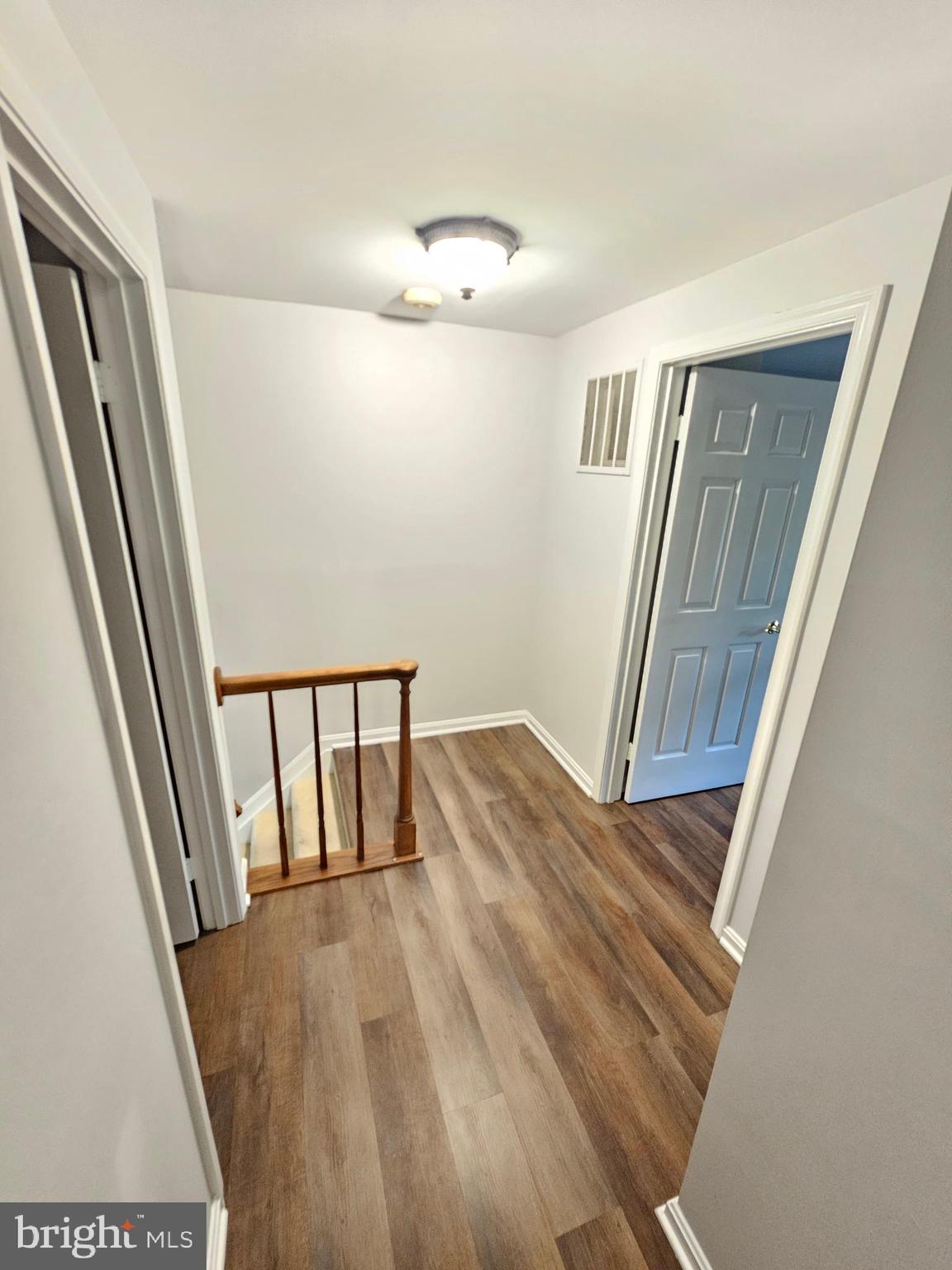 11321 Classical Lane Silver Spring, MD 20901 - Photo 35 of 66 a view of a hallway with wooden floor and staircase