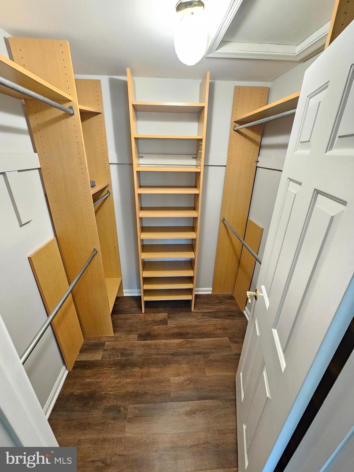 11321 Classical Lane Silver Spring, MD 20901 - Photo 45 of 66 a view of walk in closet with wooden floor and stairs