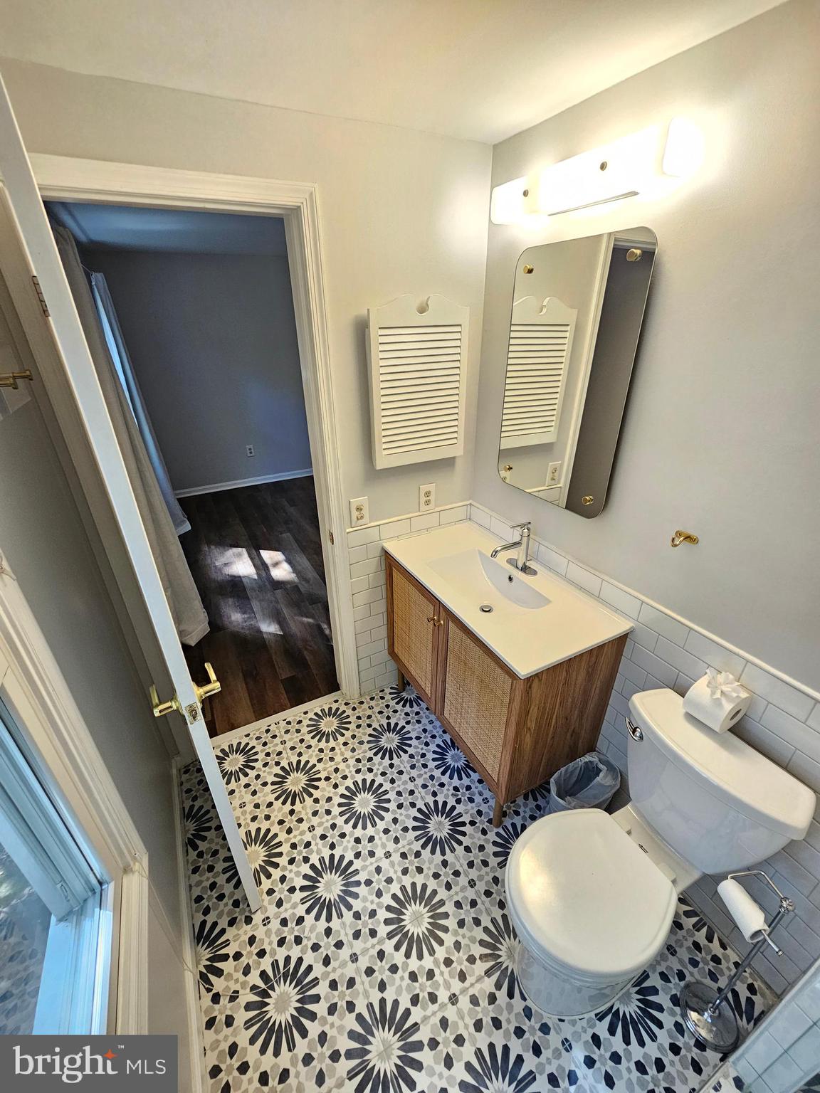 11321 Classical Lane Silver Spring, MD 20901 - Photo 48 of 66 a bathroom with a sink toilet and mirror