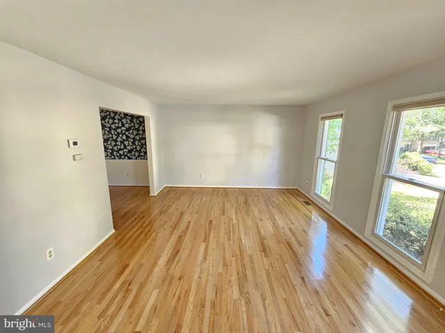 a view of a room with wooden floor and window