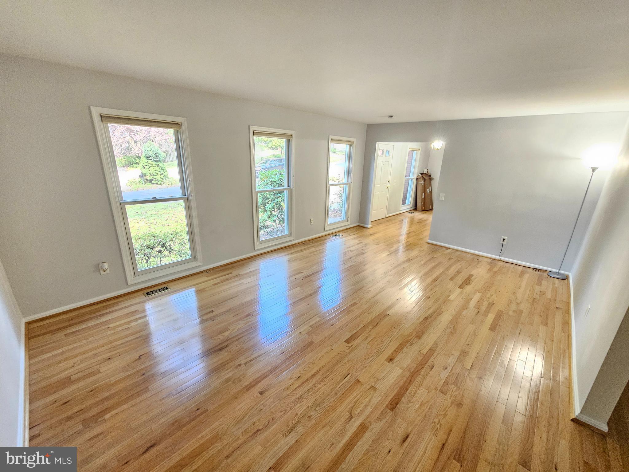 11321 Classical Lane Silver Spring, MD 20901 - Photo 8 of 66 a view of an empty room with wooden floor and a window