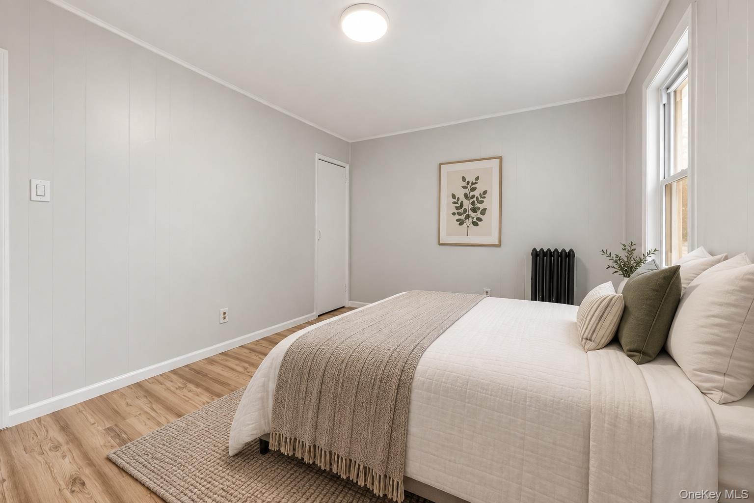 173-43 103rd Road Queens, NY 11433 - Photo 17 of 43 Wood-finish flooring, vertical paneling, and a flush mount ceiling light fixture