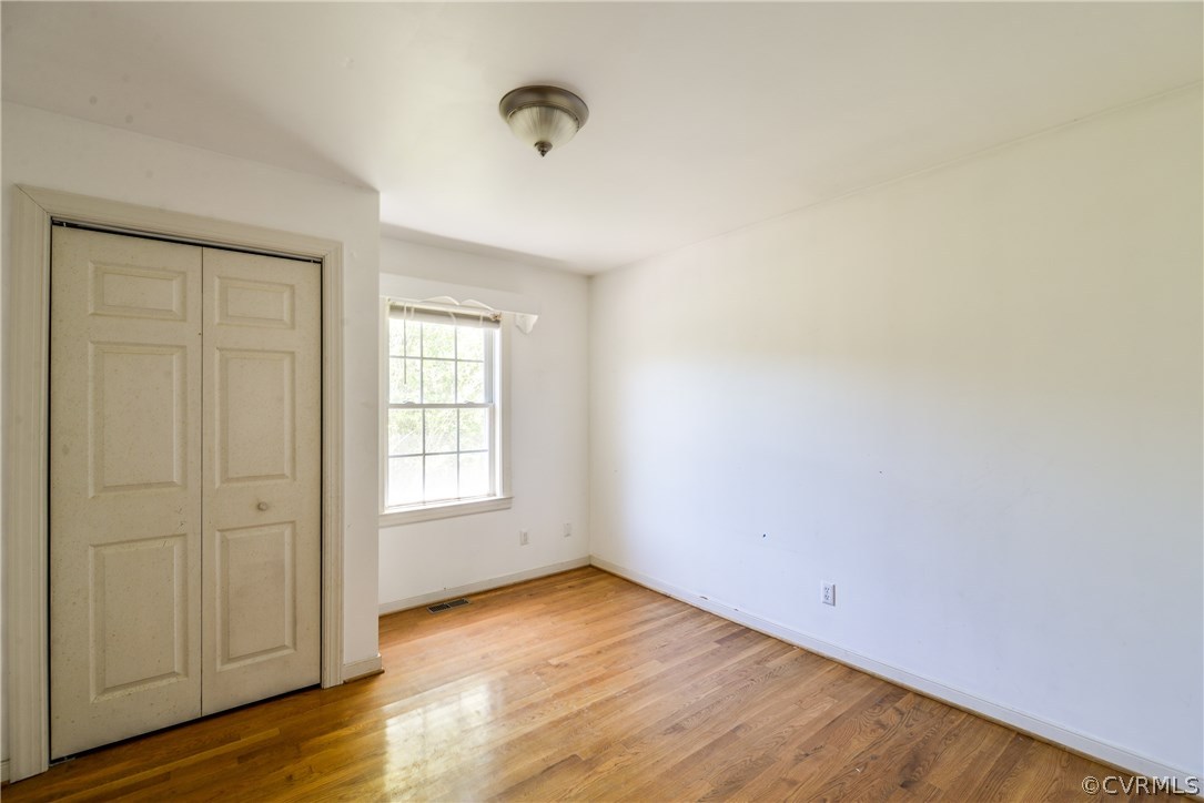 9025 Beach Road Chesterfield, VA 23838 - Photo 21 of 25 an empty room with wooden floor and windows