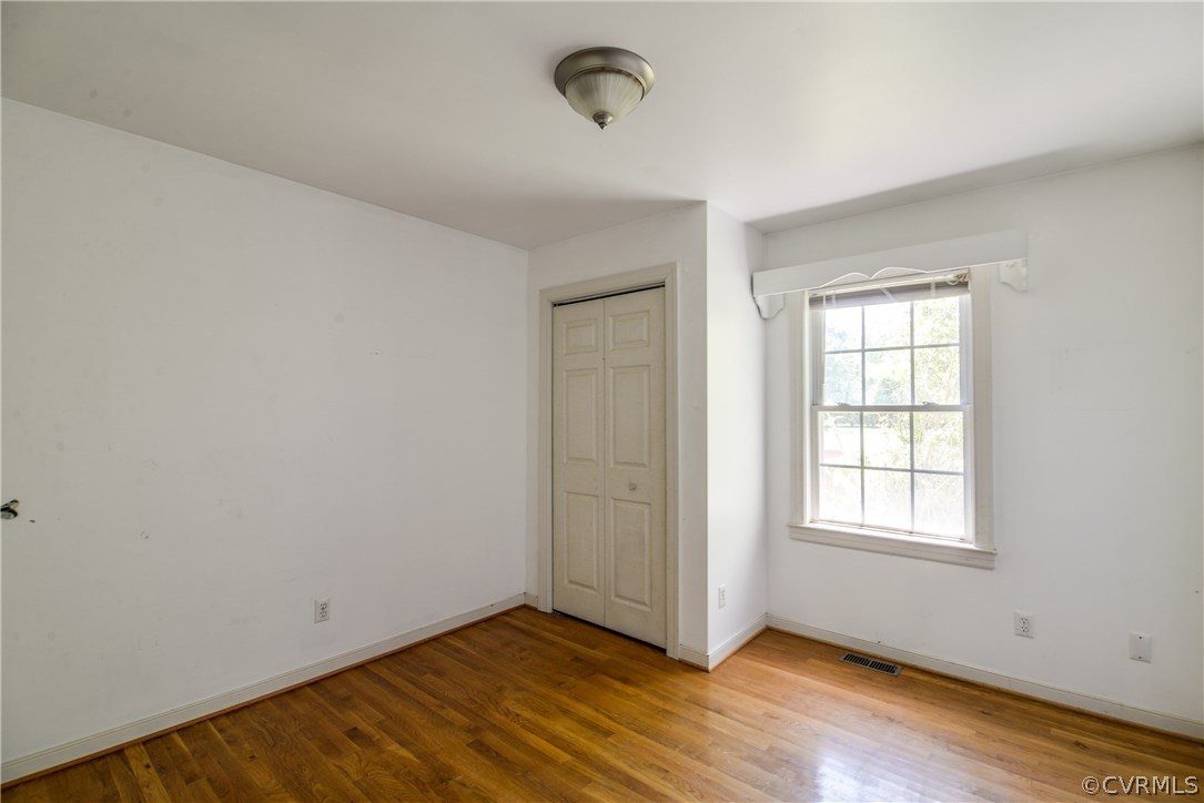 9025 Beach Road Chesterfield, VA 23838 - Photo 22 of 25 an empty room with wooden floor and windows