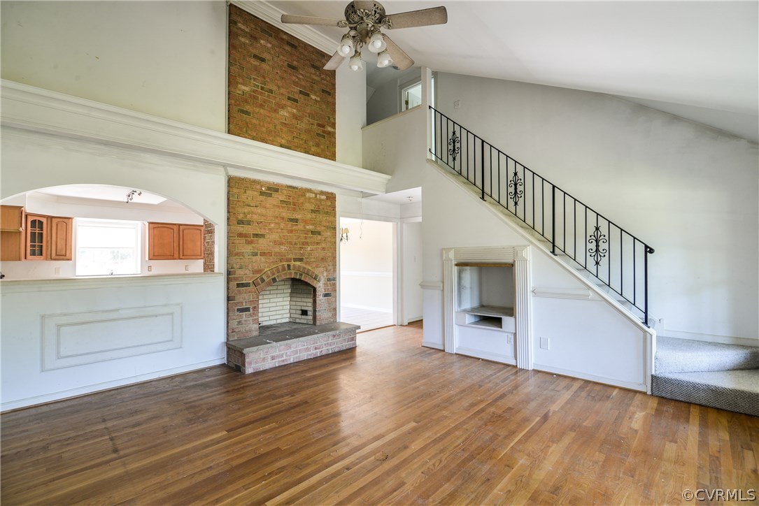 9025 Beach Road Chesterfield, VA 23838 - Photo 7 of 25 a view of a livingroom with wooden floor a fireplace and entryway