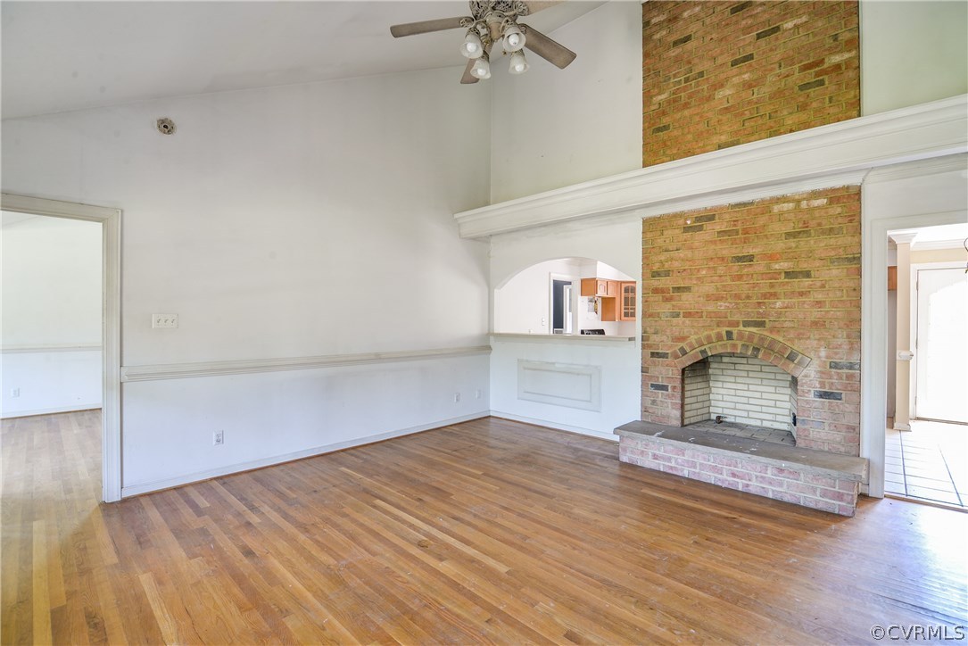 9025 Beach Road Chesterfield, VA 23838 - Photo 8 of 25 an empty room with wooden floor fireplace and windows