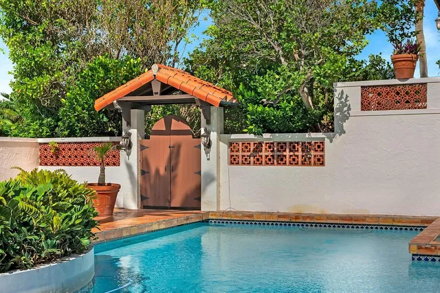 a living room with furniture fireplace and a large window