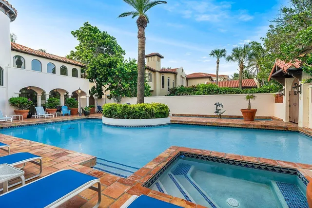 a living room with furniture a fireplace and a chandelier
