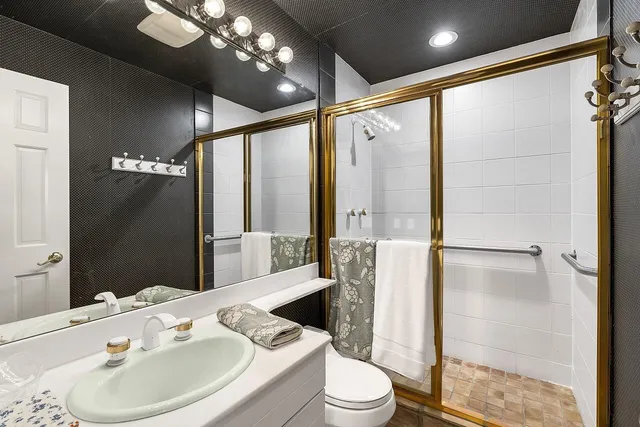 a bathroom with a sink toilet and shower