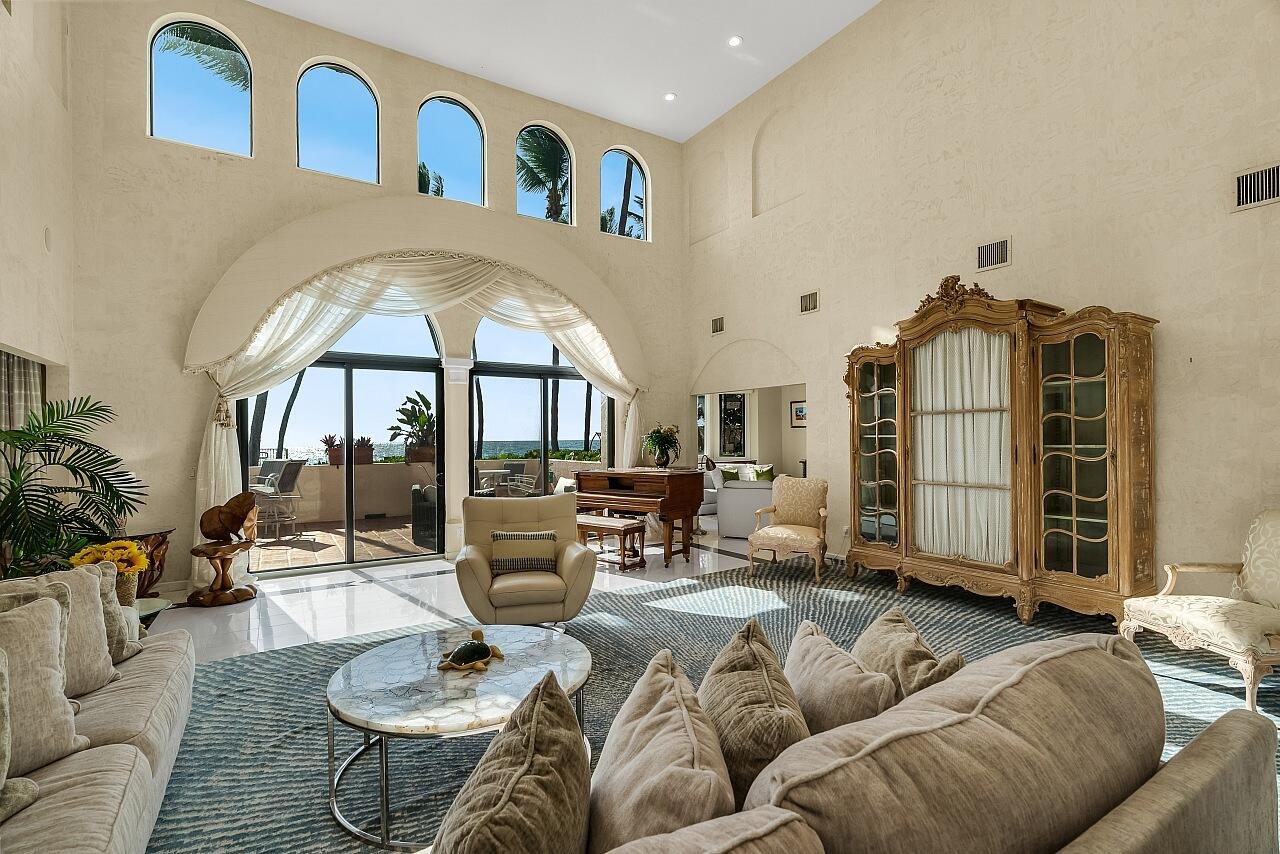 1 Ocean Lane Manalapan, FL 33462 - Photo 24 of 95 a living room with furniture a fireplace and a chandelier