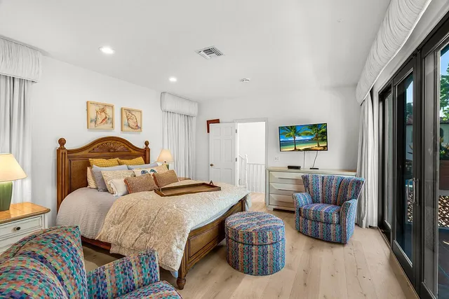 a bedroom with a bed and glass window