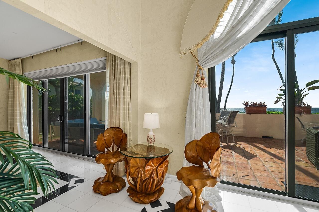 1 Ocean Lane Manalapan, FL 33462 - Photo 28 of 95 a living room with couches chairs and large windows with wooden floor