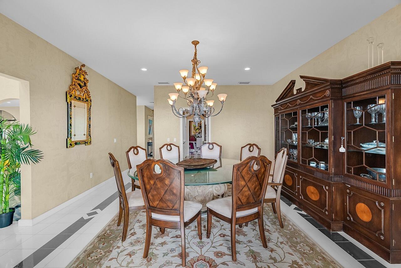 1 Ocean Lane Manalapan, FL 33462 - Photo 29 of 95 a dining room with furniture and chandelier