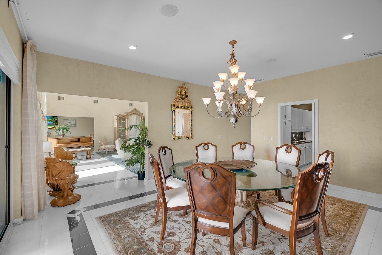 1 Ocean Lane Manalapan, FL 33462 - Photo 30 of 95 a view of a dining room with furniture and chandelier