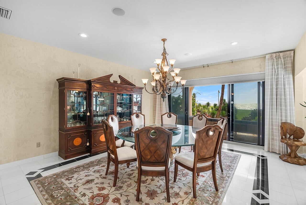 1 Ocean Lane Manalapan, FL 33462 - Photo 32 of 95 a view of a dining room with furniture and chandelier